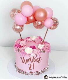 a pink birthday cake with balloons and flowers on top that says number 21 in front of it