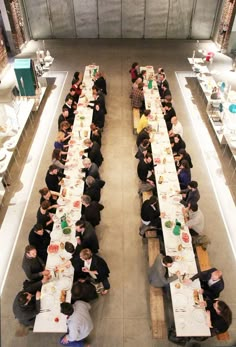 an overhead view of people eating at long tables