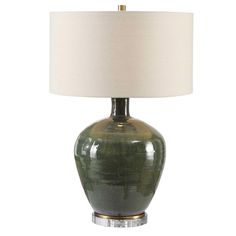 a green lamp with a white shade on it