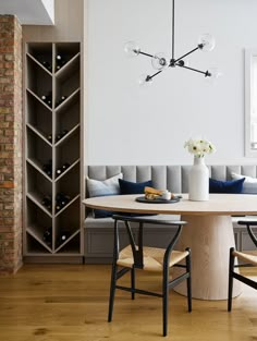 a dining room table with two chairs and a wine rack