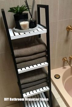 a bathroom with a sink, towel rack and bathtub in it's corner