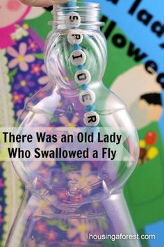 someone is holding up a glass bottle with words on it that say i know an old lady who swallowed a fly