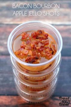 bacon bourbon apple jello shots in a clear plastic cup on a wooden table with text overlay