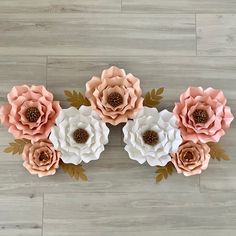 paper flowers are arranged on a wooden floor