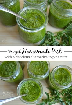 four jars filled with pesto on top of a wooden table