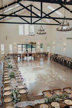 a large room with tables and chairs set up for a wedding reception in the center