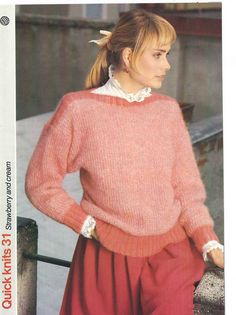 a woman wearing a pink sweater and red pants