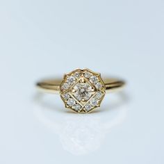 a yellow gold ring with diamonds on it