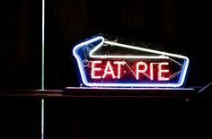 a neon sign that says eat pie on it