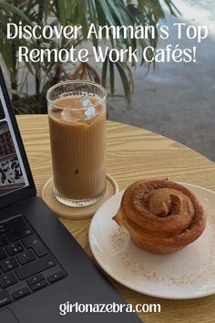 a laptop computer sitting on top of a wooden table next to a cup of coffee