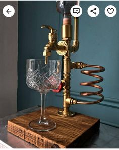 a wine glass is sitting on top of a wooden stand with a bottle in it