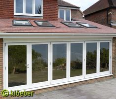 an image of a house that is being built with glass doors and windows on the roof