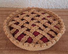 a crocheted basket sitting on top of a wooden table