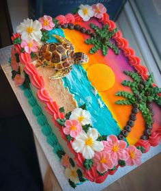 a cake decorated with flowers and a turtle