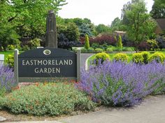 a sign for eastmoreland garden surrounded by flowers