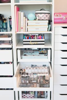 an organized closet with lots of crafting supplies and storage bins on the bottom shelf