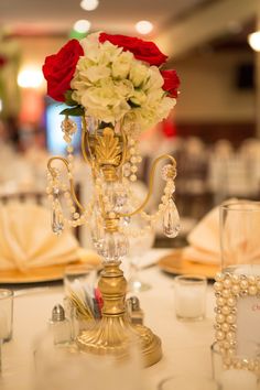 a vase with flowers on top of a table next to other place settings and napkins