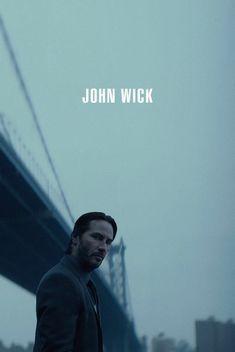 a man standing in front of a bridge with the caption john wick