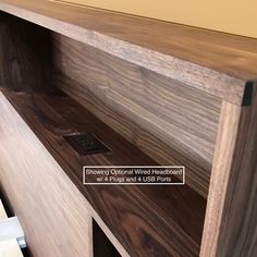 a close up of a wooden shelf with drawers and labels on the bottom part of it