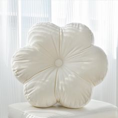 a white pillow sitting on top of a chair