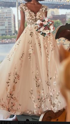 a woman in a wedding dress standing next to a chair with flowers on it and the caption that says,