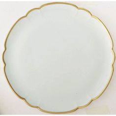 an empty white plate with gold trim around it