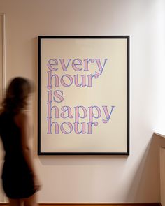 a woman is walking past a painting that says every hour is happy hour