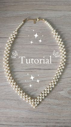 a white pearl necklace with the word'tutor'written on it and stars in the background