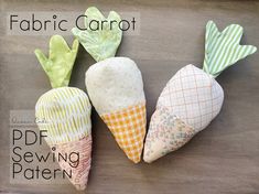 four fabric carrots are sitting next to each other on a wooden surface with text overlay that says fabric carrot sewing pattern