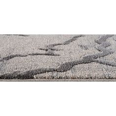 a gray rug with an abstract design on the top and bottom, in front of a white background