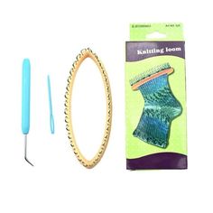 the knitting kit is in its package and it has a blue handle, needles, and an object next to it