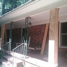 a house that is being built with wood on the front porch and stairs leading up to it