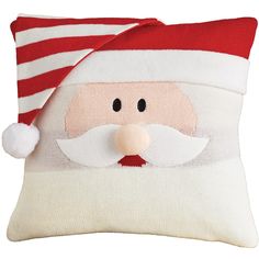 a santa clause pillow with a red and white striped hat on it's face