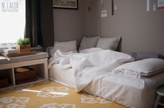 a bed sitting under a window in a bedroom