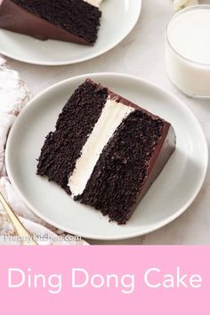 two slices of chocolate cake on white plates with pink and white flowers in the background