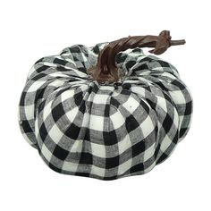 a black and white checkered pumpkin sitting on top of a table