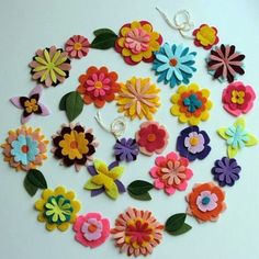 colorful felt flowers are arranged in a circle