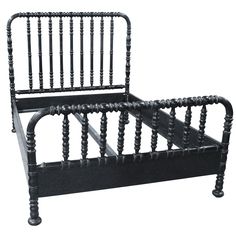 a black bed frame with wooden posts and spindles on the headboard, against a white background