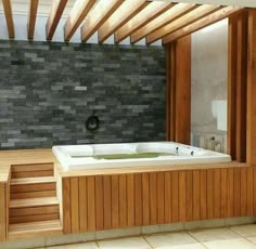 a large jacuzzi tub sitting inside of a bathroom next to a wooden wall