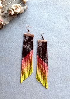 💕 Step out in style in these long fringe earrings made in stunning colors and layered to give a ombre effect. These are perfect for any occasion. Wear it for a party or a casual day out with friends.  Color used: Maroon pink orange light orange yellow Handmade and made with a lot of efforts and attention to detail. Made using strong nylon beading thread and attached with ear hook's are made of copper. Ombre Earrings, Long Fringe, Earring Making, Rose Orange, Long Fringes, Diy Crafts Jewelry, Bohemian Earrings, Crafts Jewelry, Seed Bead Earrings