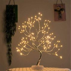 a lighted tree sitting on top of a wooden table