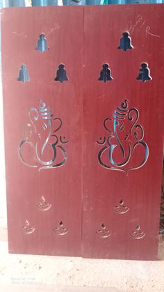 two red wooden doors with designs on them