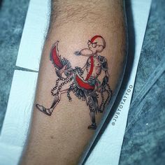 a man's leg with a tattoo on it that has a cartoon character riding a horse