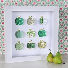 an apple and pear shadow box with green apples