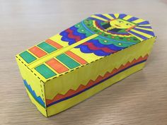 a brightly colored box sitting on top of a wooden table