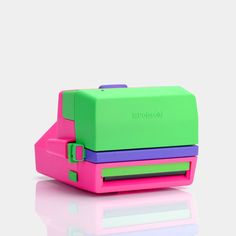 a pink, green and purple case sitting on top of each other