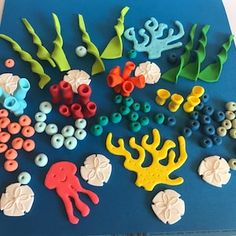 there are many different types of sea animals on the blue board with buttons and beads