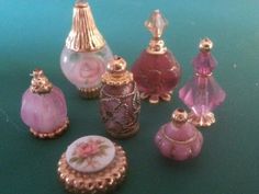 an assortment of miniature perfume bottles on a table