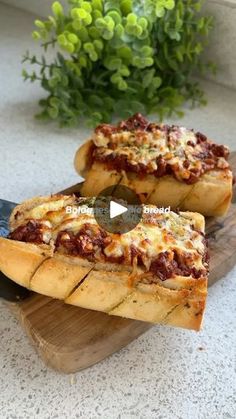 two slices of pizza sitting on top of a cutting board