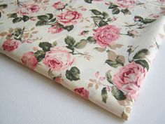 the fabric has pink roses on it